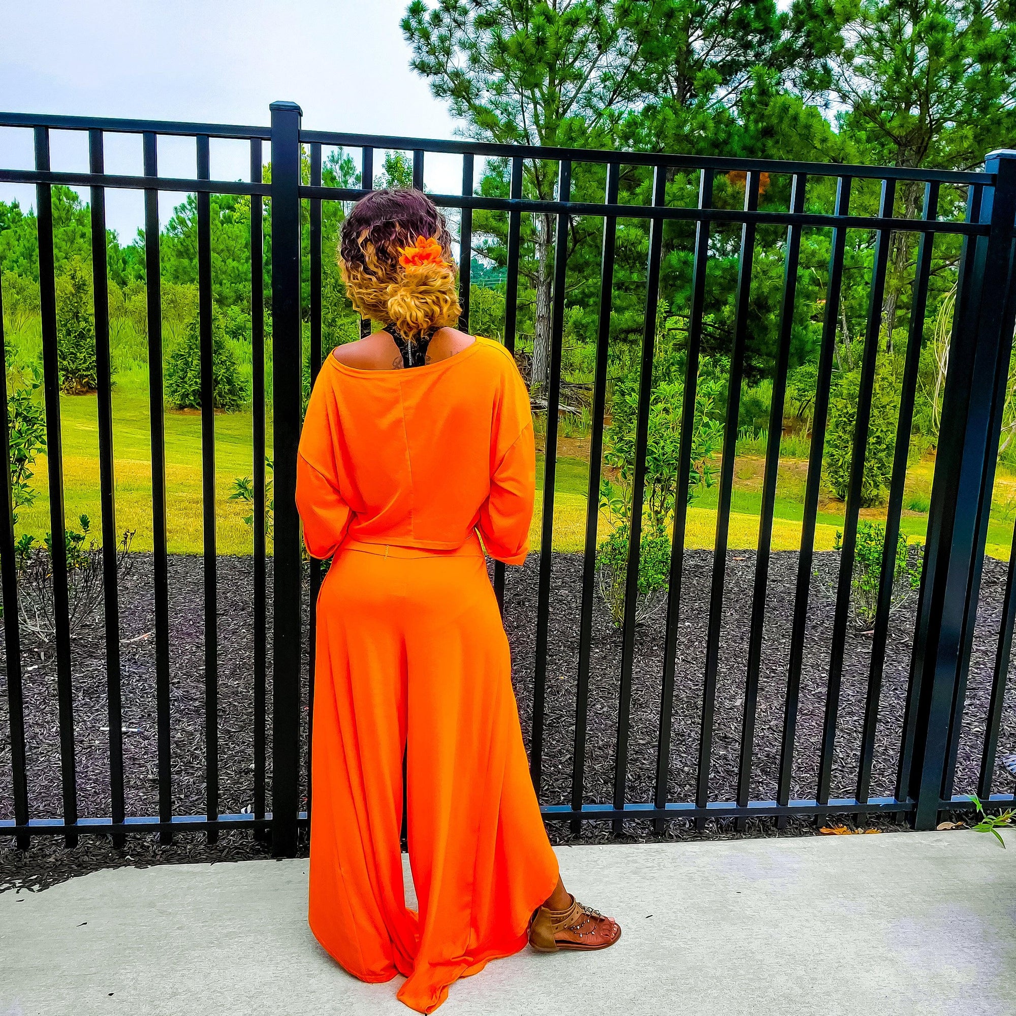 Orange two piece long sleeve crop top and matching wide leg pants