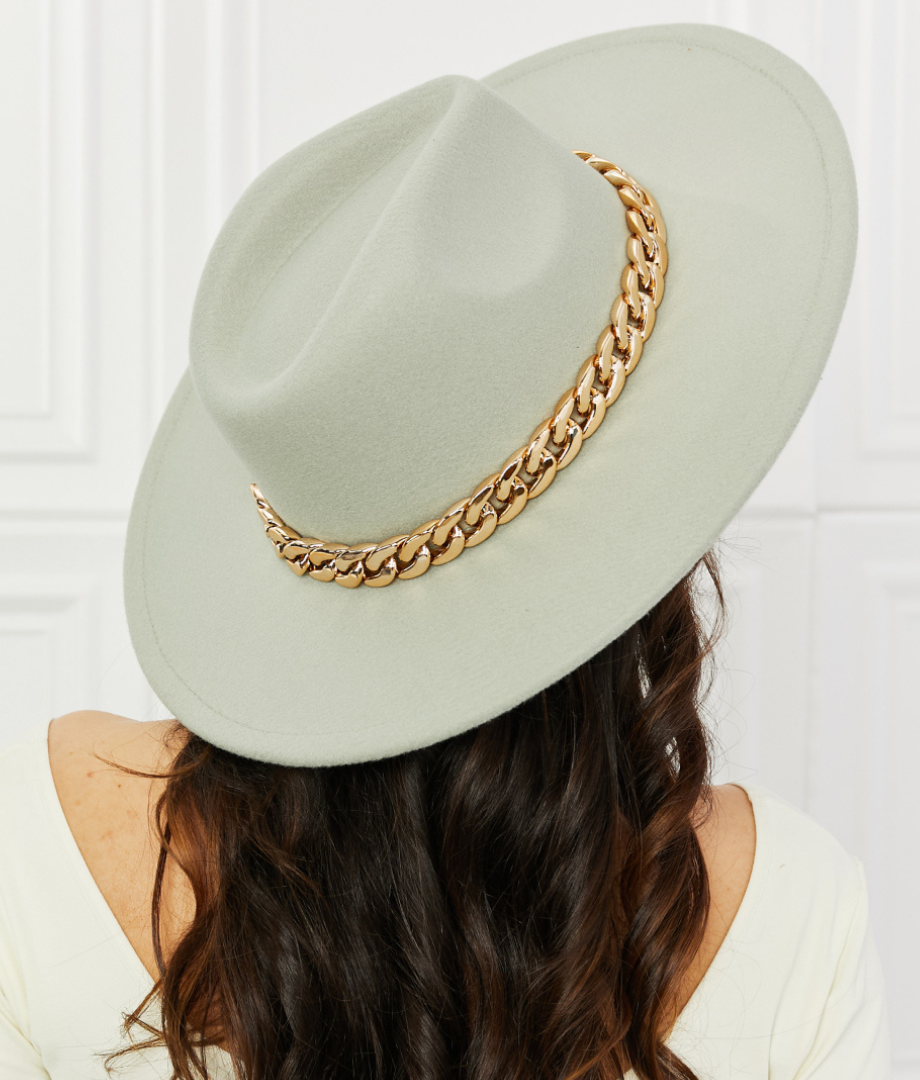 mint green fedora with gold chain around brim