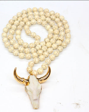 Cream Longhorn Bull Skull Necklace with lava stone beading.