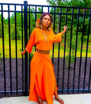 Orange two piece long sleeve crop top and matching wide leg pants
