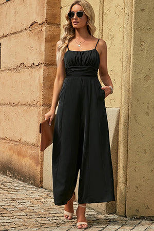 Black spaghetti strap wide leg jumpsuit with seam detail and cutout tieback