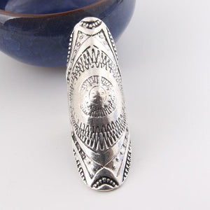 Silver Carved Full Finger Ring laying against blue bowl
